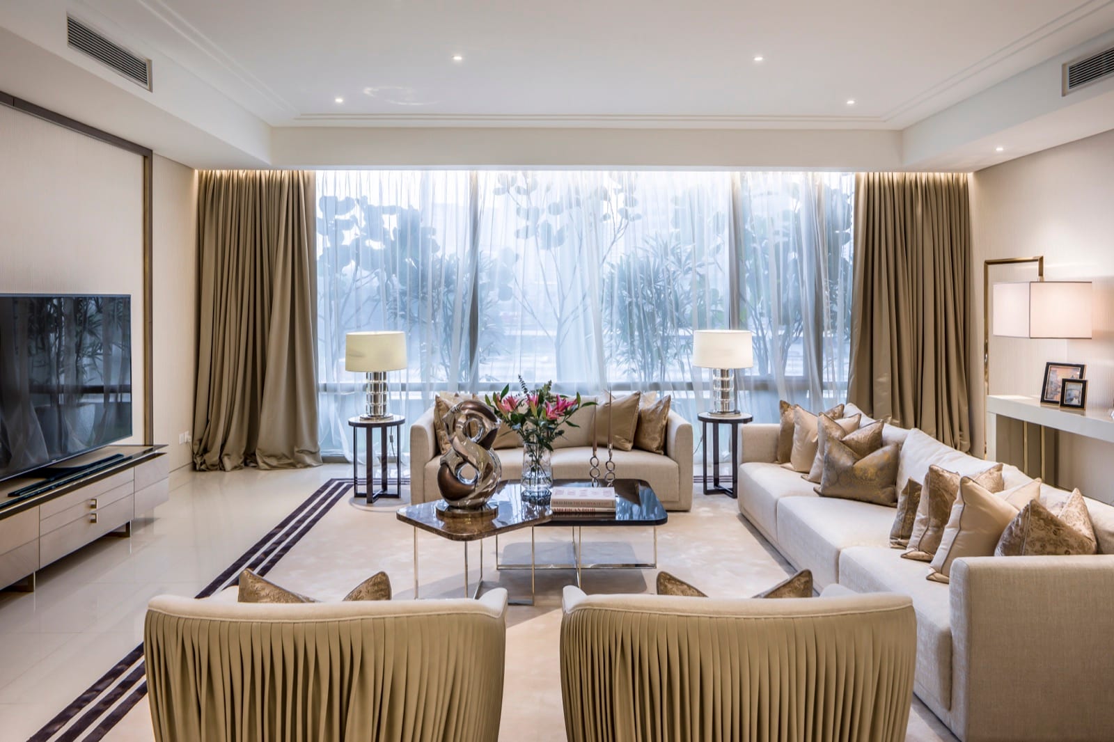 Furnished living room with full-height curtains and cream seating at Pavilion Damansara Heights; project image